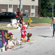Lakiah Payne (left) walks with Michael Brown's sister, Deja Brown, as they visit a memorial for him that is set up on the spot where he fell after he was shot by police on Aug. 19, 2014, in Ferguson, Mo.
Joe Raedle/Getty Images